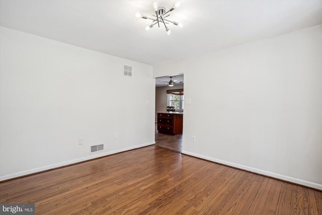 13925 Wayside Dr, Clarksville, MD 21029 - spare room with a chandelier, dark wood-style flooring, and baseboards