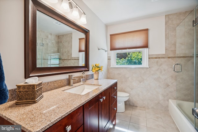 13925 Wayside Dr, Clarksville, MD 21029 - full bath featuring vanity, toilet, tile patterned flooring, tile walls, and bath / shower combo with glass door