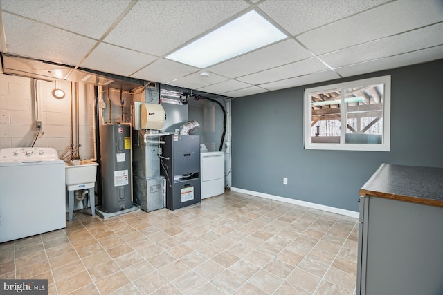 13925 Wayside Dr, Clarksville, MD 21029 - basement featuring water heater, a drop ceiling, washer and clothes dryer, a sink, and baseboards