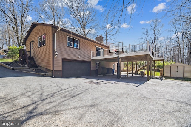 13925 Wayside Dr, Clarksville, MD 21029 - view of property exterior with stairway, a chimney, an attached garage, and asphalt driveway