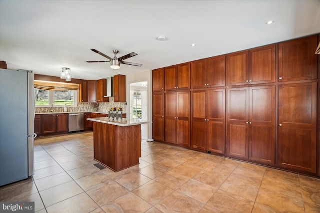 13925 Wayside Dr, Clarksville, MD 21029 - kitchen featuring appliances with stainless steel finishes, light countertops, ceiling fan, decorative backsplash, and light tile patterned floors