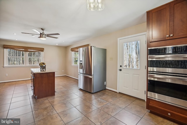 13925 Wayside Dr, Clarksville, MD 21029 - kitchen with appliances with stainless steel finishes, a ceiling fan, a center island, baseboards, and light tile patterned floors