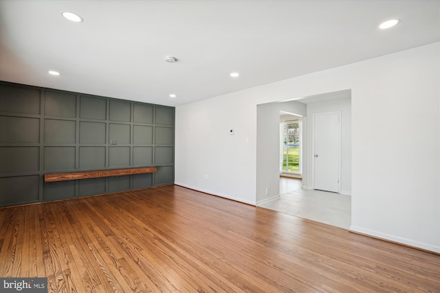 13925 Wayside Dr, Clarksville, MD 21029 - unfurnished living room with wood finished floors, a decorative wall, recessed lighting, and baseboards