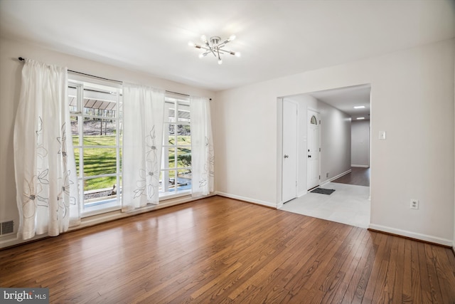 13925 Wayside Dr, Clarksville, MD 21029 - spare room featuring wood-type flooring, baseboards, and a chandelier