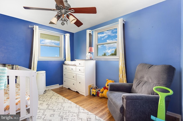 612 Colonial Dr, Dallastown, PA 17313 - bedroom featuring wood finished floors, a ceiling fan, baseboards, and a crib