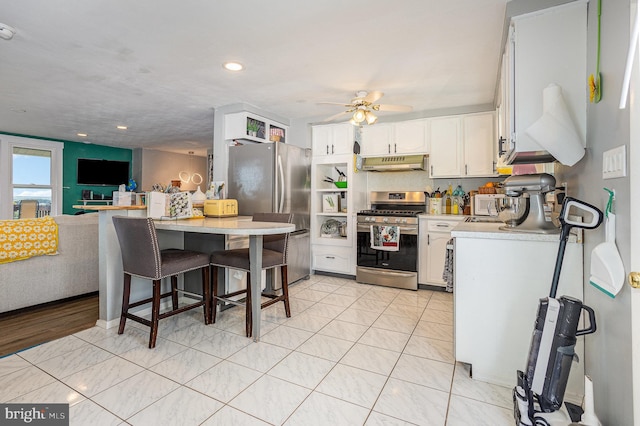 612 Colonial Dr, Dallastown, PA 17313 - kitchen featuring appliances with stainless steel finishes, under cabinet range hood, light countertops, white cabinets, and open floor plan