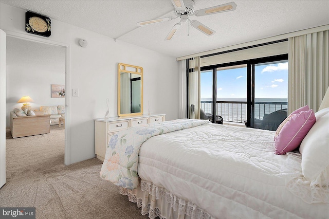 11100 Coastal Hwy Unit 904, Ocean City, MD 21842 - carpeted bedroom featuring access to outside, a water view, a textured ceiling, and ceiling fan