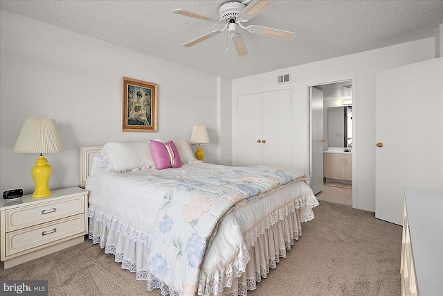11100 Coastal Hwy Unit 904, Ocean City, MD 21842 - bedroom with carpet flooring, a closet, ensuite bathroom, a textured ceiling, and a ceiling fan