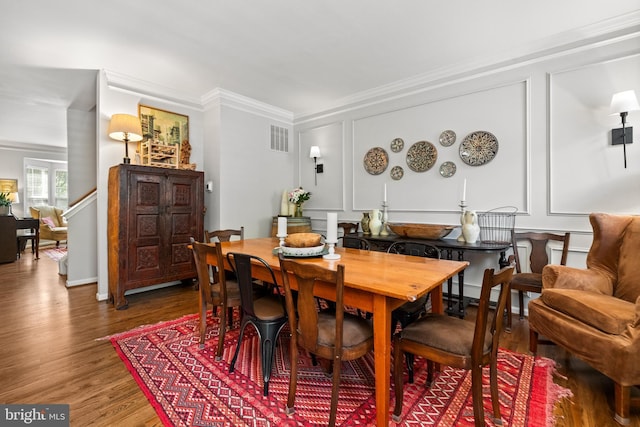 43614 Dunhill Cup Sq, Ashburn, VA 20147 - dining room featuring ornamental molding, wood finished floors, and a decorative wall