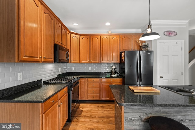 43614 Dunhill Cup Sq, Ashburn, VA 20147 - kitchen featuring black appliances, ornamental molding, backsplash, wood finished floors, and pendant lighting