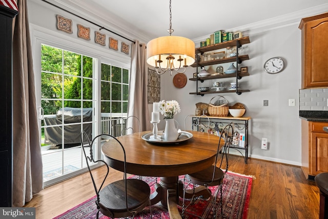 43614 Dunhill Cup Sq, Ashburn, VA 20147 - dining room with crown molding, plenty of natural light, wood finished floors, baseboards, and a chandelier