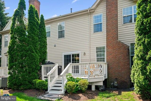 43614 Dunhill Cup Sq, Ashburn, VA 20147 - back of property with a deck, a chimney, central AC, and brick siding