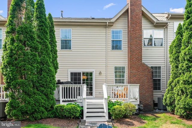 43614 Dunhill Cup Sq, Ashburn, VA 20147 - rear view of house with a deck, a chimney, and cooling unit