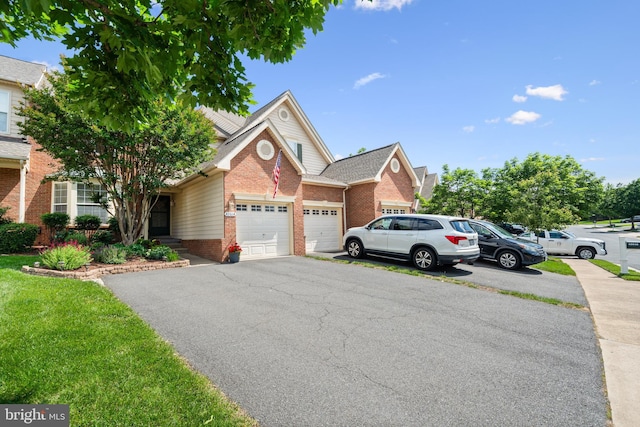43614 Dunhill Cup Sq, Ashburn, VA 20147 - view of front of house with brick siding, driveway, and an attached garage