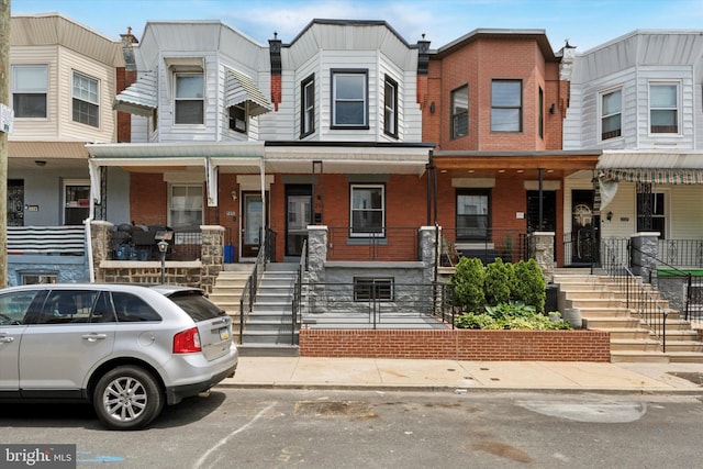 233 S Frazier St, Philadelphia, PA 19139 - view of property with a porch, brick siding, and stairs