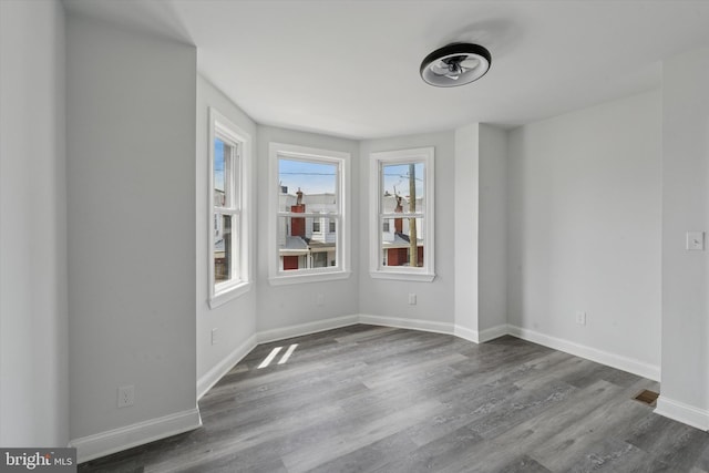 233 S Frazier St, Philadelphia, PA 19139 - unfurnished room with dark wood finished floors and baseboards