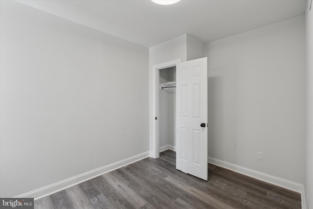 233 S Frazier St, Philadelphia, PA 19139 - unfurnished bedroom with dark wood-style flooring, baseboards, and a closet
