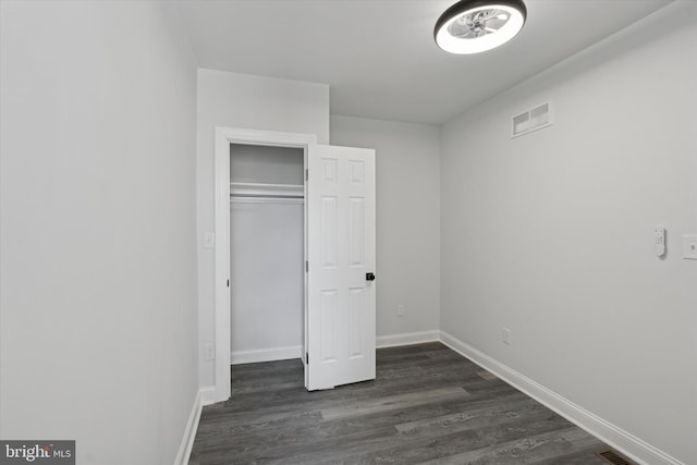 233 S Frazier St, Philadelphia, PA 19139 - unfurnished bedroom featuring dark wood-style flooring, baseboards, and a closet