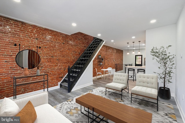 233 S Frazier St, Philadelphia, PA 19139 - living room featuring baseboards, brick wall, wood finished floors, stairway, and recessed lighting