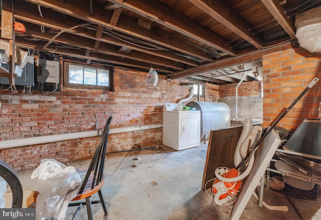 28 Chestnut St, Salem, NJ 08079 - below grade area featuring washer / dryer, oil tank, brick wall, and electric panel