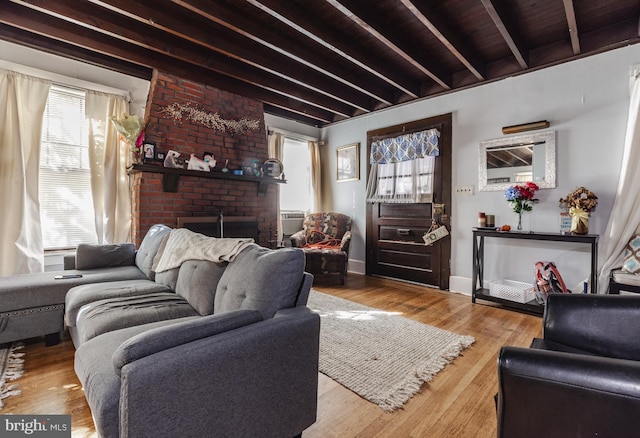 28 Chestnut St, Salem, NJ 08079 - living room featuring healthy amount of natural light, beamed ceiling, a brick fireplace, wood finished floors, and baseboards