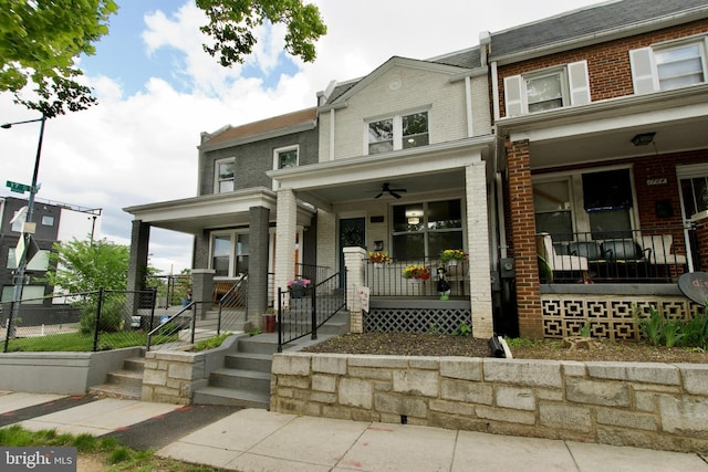 1702 Lang Pl NE, Washington, DC 20002 - multi unit property featuring covered porch, brick siding, a ceiling fan, and a gate