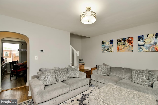 1702 Lang Pl NE, Washington, DC 20002 - living room featuring wood finished floors, stairway, and arched walkways