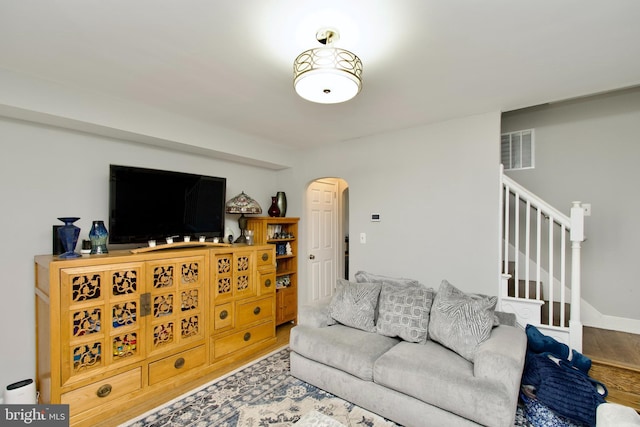 1702 Lang Pl NE, Washington, DC 20002 - living area featuring arched walkways, wood finished floors, and stairs