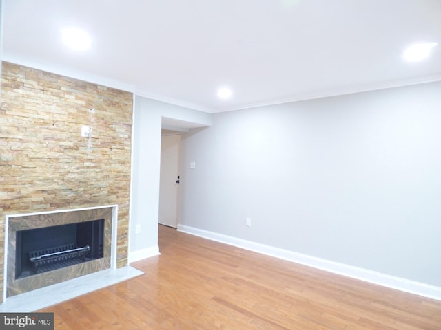 2216 Springwood Dr Unit 202, Reston, VA 20191 - unfurnished living room featuring a fireplace with flush hearth, wood finished floors, baseboards, crown molding, and recessed lighting