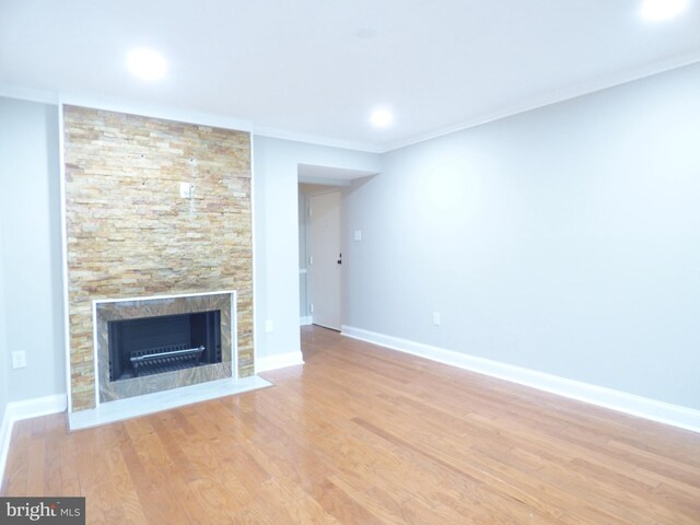 2216 Springwood Dr Unit 202, Reston, VA 20191 - unfurnished living room featuring light wood-type flooring, a fireplace, baseboards, and crown molding