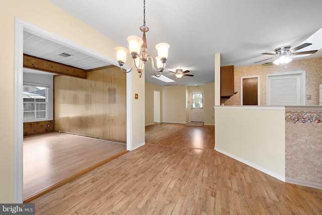 127 Mohican Ln, Little Egg Harbor Twp, NJ 08087 - spare room featuring a chandelier, light wood-style flooring, ceiling fan, baseboards, and wooden walls