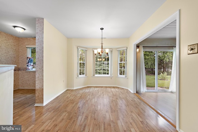 127 Mohican Ln, Little Egg Harbor Twp, NJ 08087 - unfurnished dining area featuring a chandelier, healthy amount of natural light, wood finished floors, and baseboards
