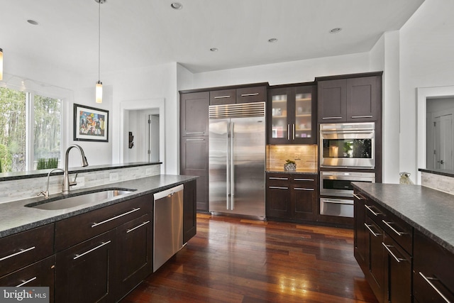 1713 N Wayne St, Arlington, VA 22201 - kitchen featuring appliances with stainless steel finishes, a sink, tasteful backsplash, dark wood-style flooring, and decorative light fixtures