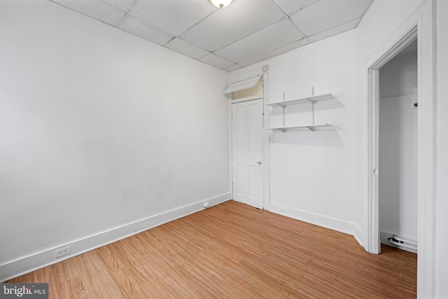 812 Powers St, Baltimore, MD 21211 - unfurnished bedroom featuring light wood finished floors, a paneled ceiling, baseboards, and a closet