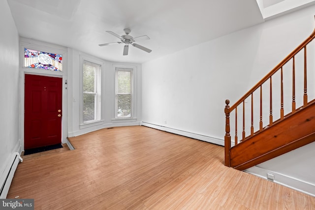 812 Powers St, Baltimore, MD 21211 - entrance foyer featuring baseboard heating, stairway, wood finished floors, and ceiling fan