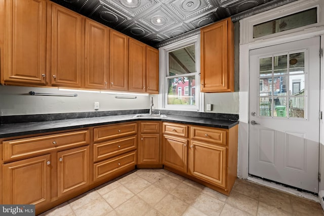 812 Powers St, Baltimore, MD 21211 - kitchen with a sink, dark countertops, and brown cabinets