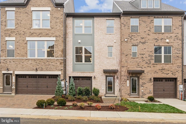 16519 Saint Marion Way, Bowie, MD 20716 - townhome / multi-family property featuring an attached garage, driveway, and brick siding