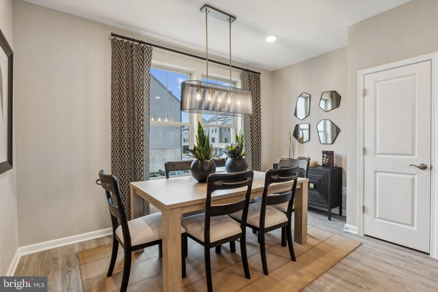 16519 Saint Marion Way, Bowie, MD 20716 - dining space with a chandelier, light wood finished floors, and baseboards