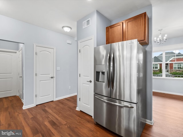 306 Prospect St, Milton, DE 19968 - kitchen featuring stainless steel fridge, dark wood-type flooring, brown cabinetry, a chandelier, and baseboards