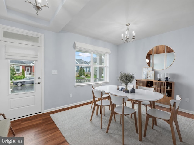 306 Prospect St, Milton, DE 19968 - dining space with a chandelier, wood finished floors, and baseboards