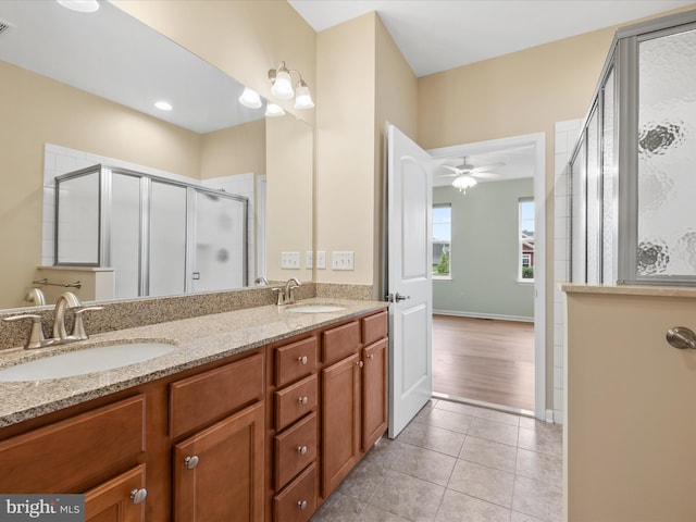 306 Prospect St, Milton, DE 19968 - full bath with double vanity, a shower stall, a ceiling fan, tile patterned floors, and baseboards