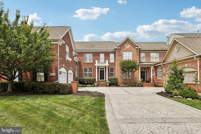 18442 Lanier Island Sq, Leesburg, VA 20176 - colonial-style house with curved driveway, brick siding, a front yard, and a garage