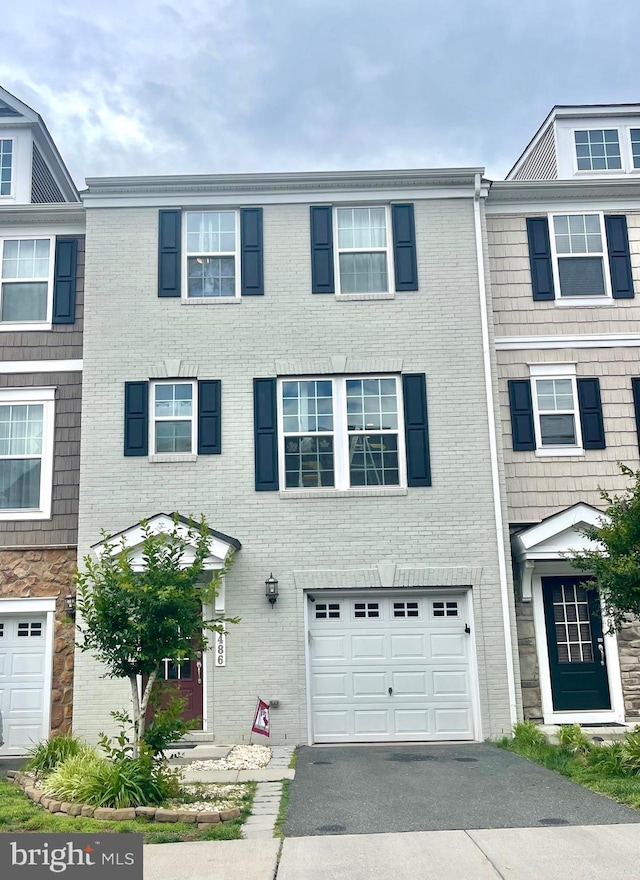 8486 Craggan Ln, Manassas, VA 20109 - view of property featuring driveway, an attached garage, and brick siding
