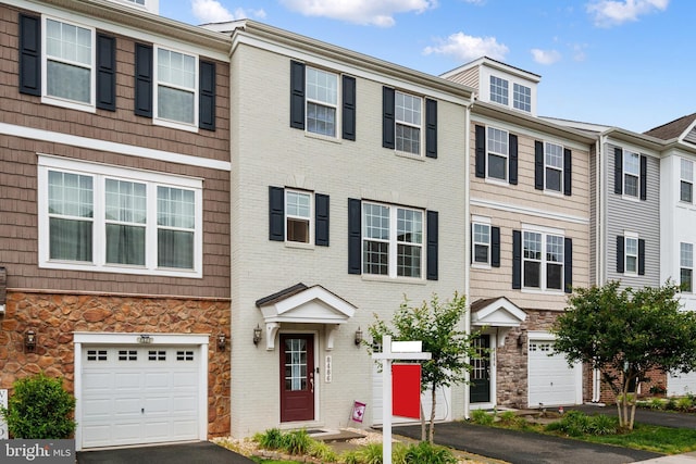 8486 Craggan Ln, Manassas, VA 20109 - view of property featuring a garage, stone siding, driveway, and brick siding