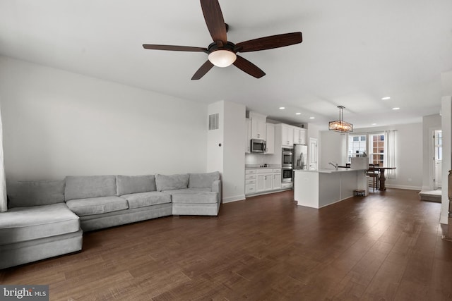 8486 Craggan Ln, Manassas, VA 20109 - living area featuring ceiling fan, recessed lighting, dark wood finished floors, and baseboards