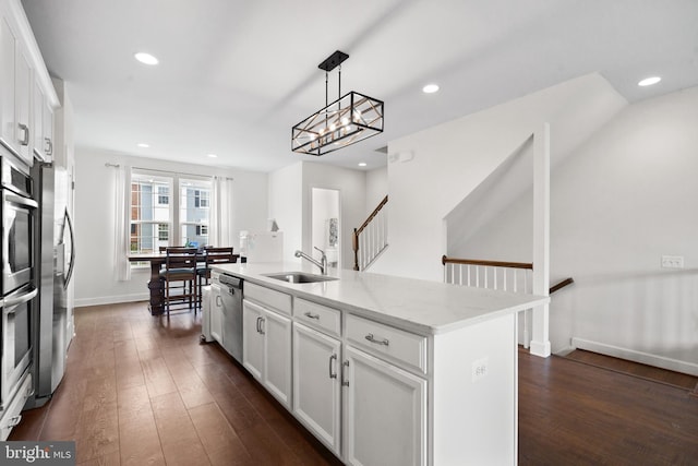 8486 Craggan Ln, Manassas, VA 20109 - kitchen featuring a sink, appliances with stainless steel finishes, dark wood finished floors, white cabinets, and recessed lighting