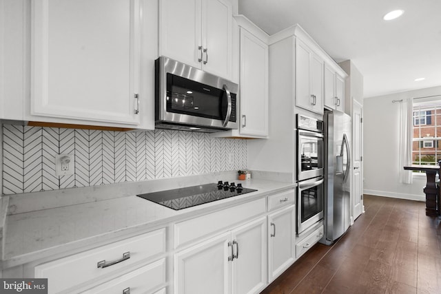 8486 Craggan Ln, Manassas, VA 20109 - kitchen featuring appliances with stainless steel finishes, white cabinets, tasteful backsplash, recessed lighting, and dark wood-style floors