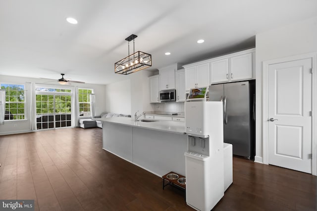 8486 Craggan Ln, Manassas, VA 20109 - kitchen featuring appliances with stainless steel finishes, a ceiling fan, dark wood-style floors, white cabinetry, and open floor plan