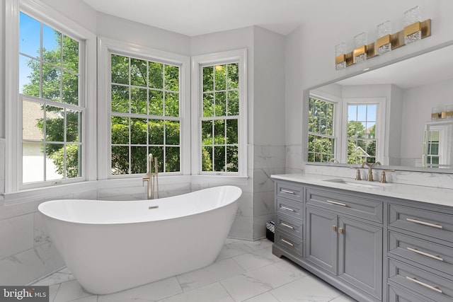 411 Merion Hill Ln, Conshohocken, PA 19428 - full bath featuring plenty of natural light, marble look tiles, vanity, a freestanding bath, and tile walls