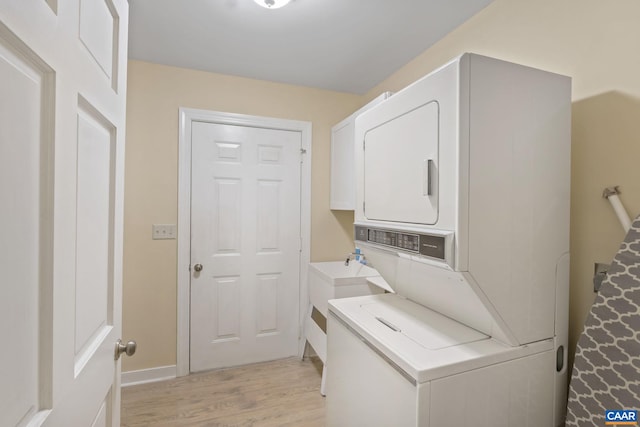 2 Whippoorwill Ln, Palmyra, VA 22963 - washroom with stacked washing machine and dryer, light wood finished floors, and baseboards